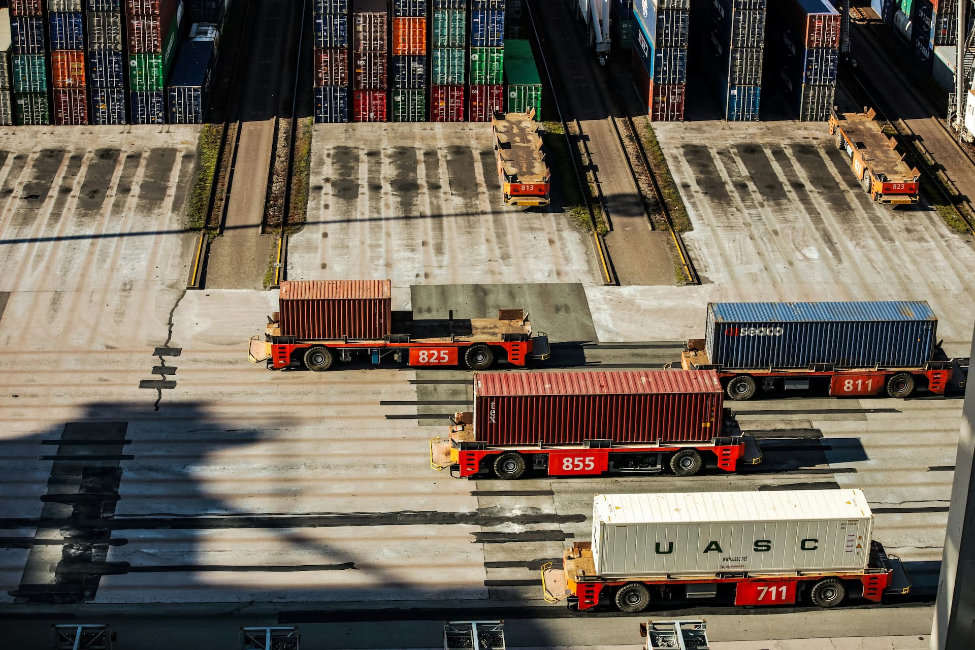 Shipping containers transported in a container yard. Credit: Bernd Dittrich, Unsplash.