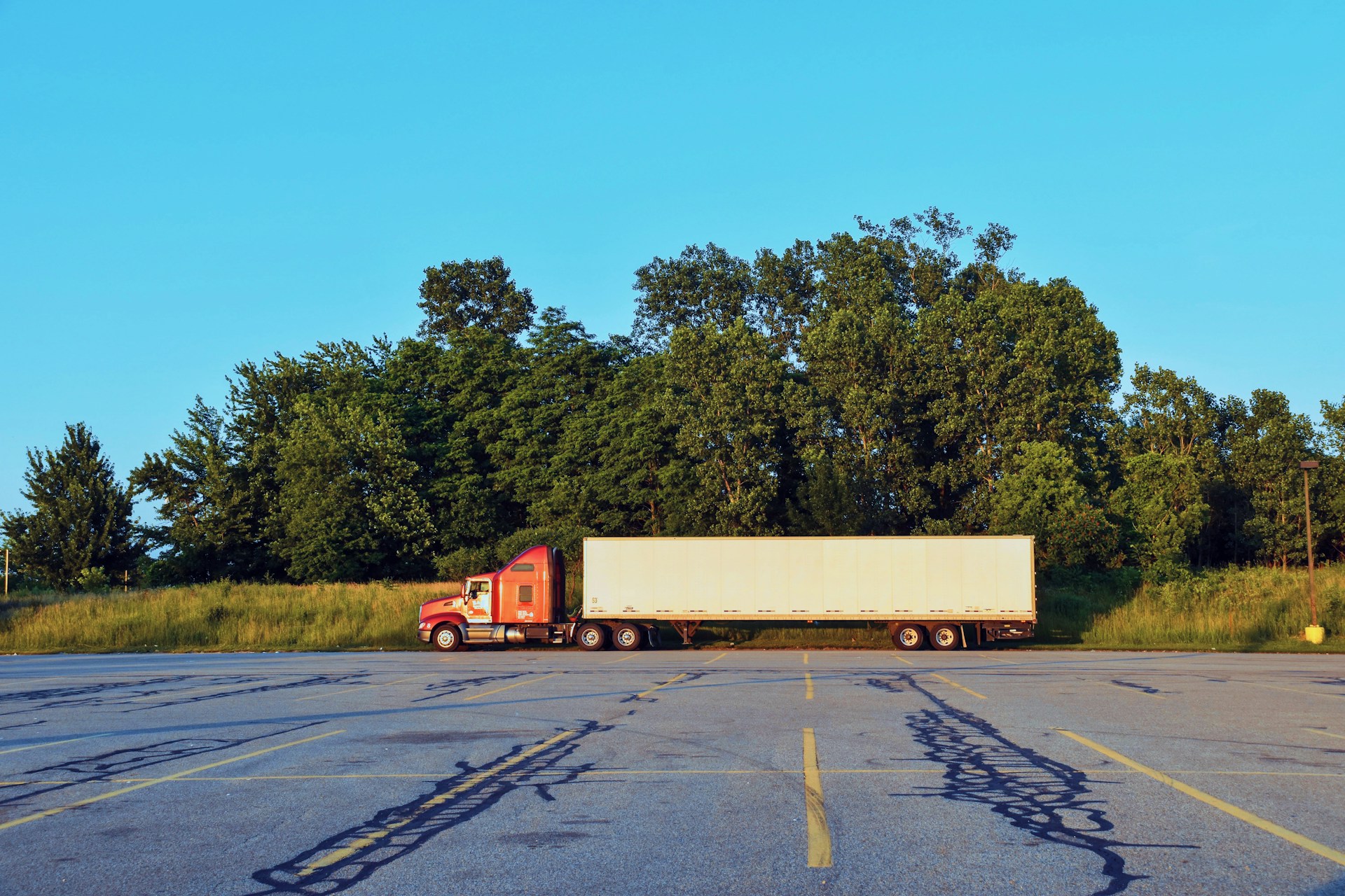 Parked semi-truck in an empty lot. Credit: Christopher Paul High, Unsplash