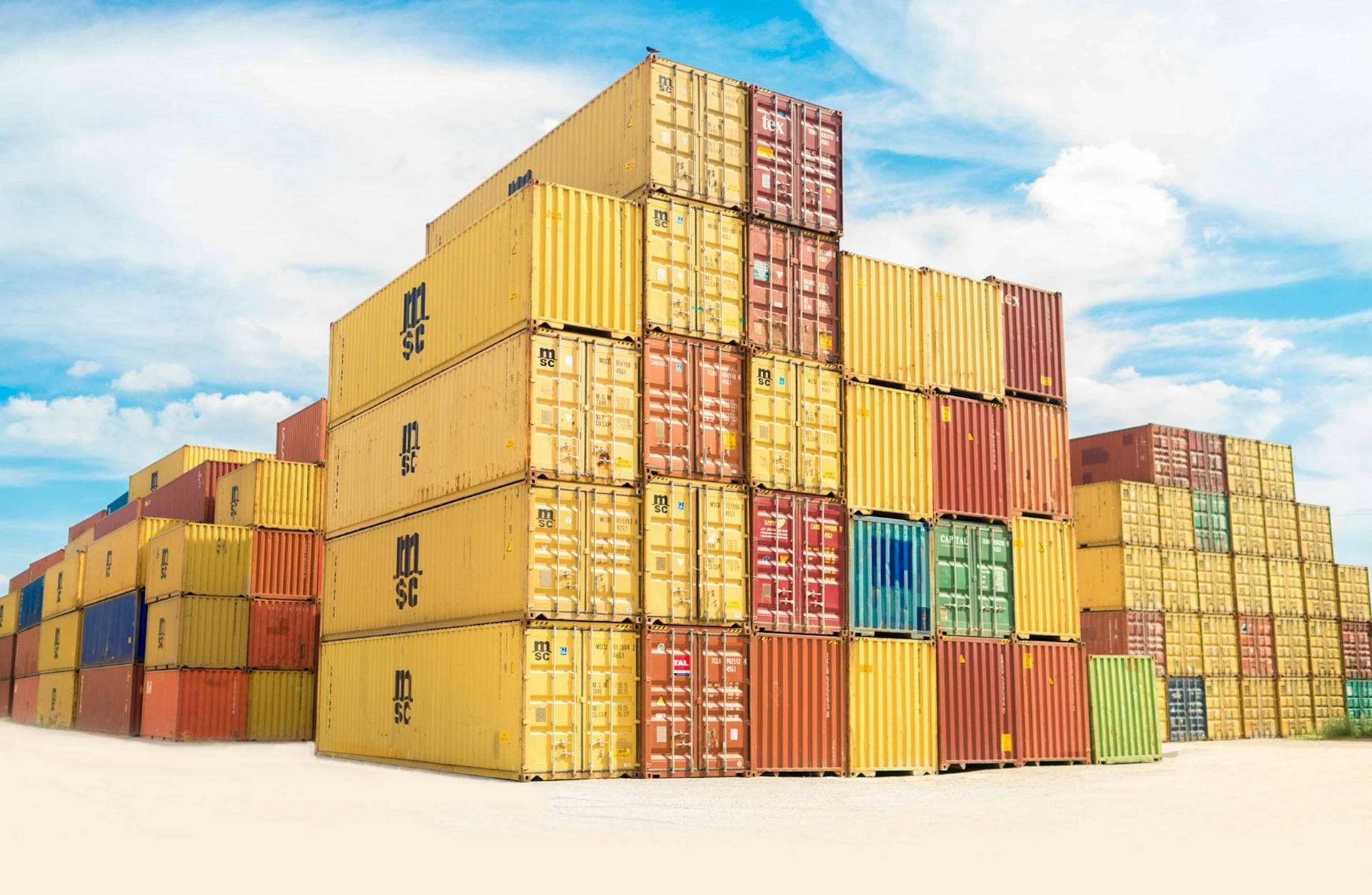 Stacks of colorful containers under a clear, sunny sky. Credit frank mckenna, Unsplash.