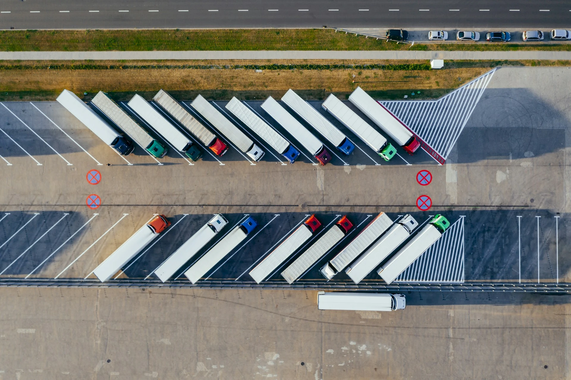 Top view of trucks parked in a lot. Credit: Marcin Jozwiak, Unsplash.